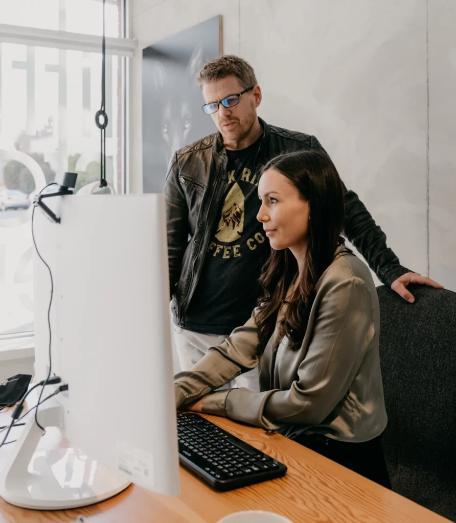 Jobie and Holly handling permit submission at office computer in Little Star HQ